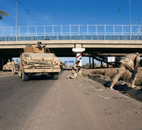 Securing the Front Line: U.S. soldiers from the Fighting 69, a New York National Guard unit, shut down Route Irish, the highway between Baghdad International Airport and central Baghdad, on a mission to search for possible Improvised Explosive Devices (IEDs).