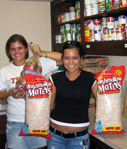 Two members of the student organization, Texas Lassos, who volunteer at the Eastside Community Connection food pantry every week helping pack food.