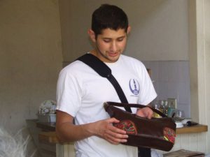 Yilver Aguilera, a Spanish/Finance major, holding a handcrafted purse made by a Panamanian showmaker. Photo courtesy Yilver Aguilera