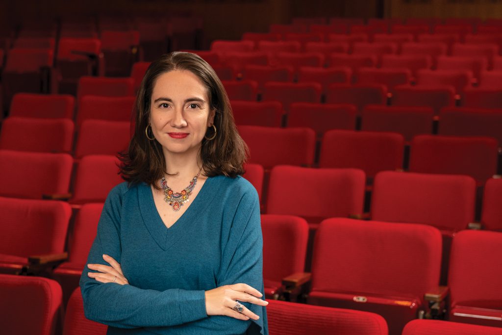 Donna Kornhaber standing in an empty movie theater.