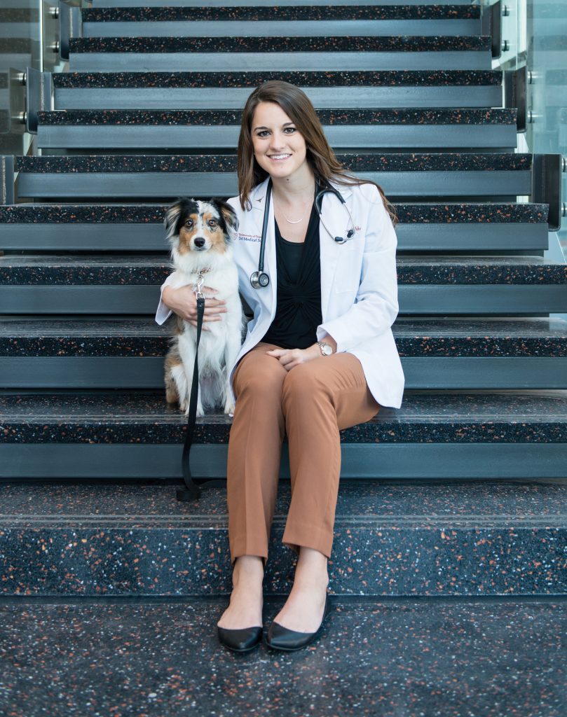 Psychology alumna Cierra Grubbs and her dog, Koda, in the Dell Medical School’s Health Learning Building.