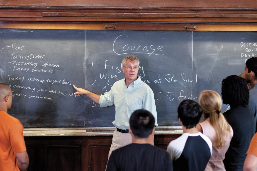 Daniel Bonevac, professor of philosophy and Human Dimensions of Organizations gives a lesson to students before a blackboard.