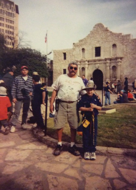 A younger Garza and his dad in front of the Alamo at the end of a Boy Scout Mission Trail Hike.