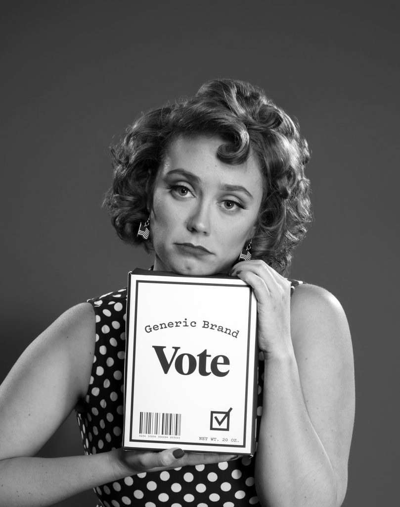 A tongue-in-cheek black and white photo of a sad-looking woman holding a "Generic Vote" branding box.