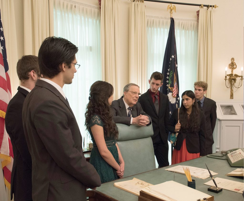 Larry Temple speaks with Larry Temple Scholarship winners during a tour of the LBJ Library Oval Office replica on Jan. 19, 2016.