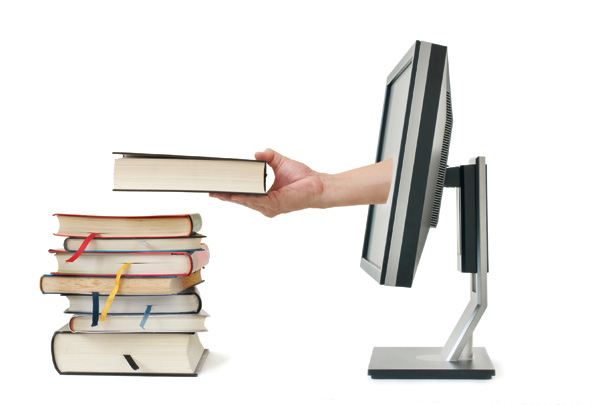 hand reaching out from monitor to place book on top of stack of books