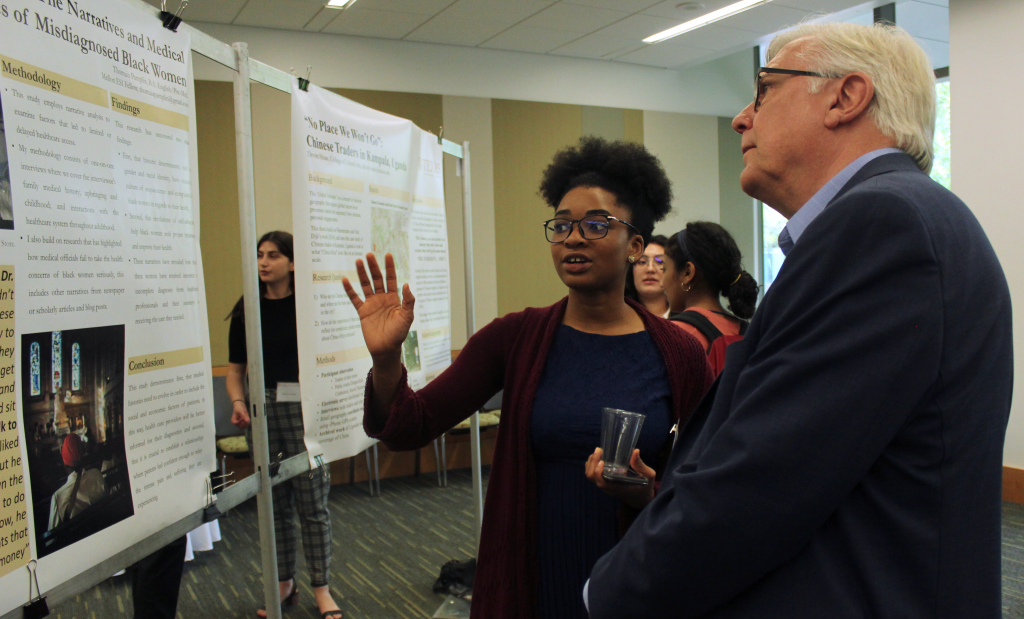 Thomaia Pamplin explains her research poster to Randy Diehl. 