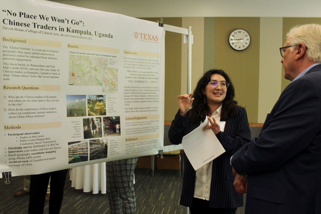 Devon Hsiao explains her research poster to Randy Diehl. 