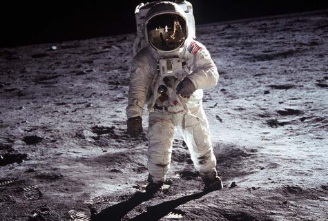 U.S. astronaut in space suit standing on the moon.