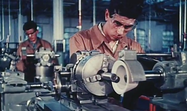 A machine shop worker using tools.