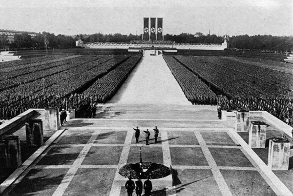 a Nazi demonstration with thousands of people lined up at a square.