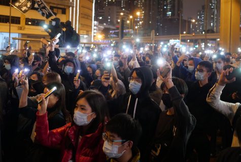 protesters holding up phones as flashlights