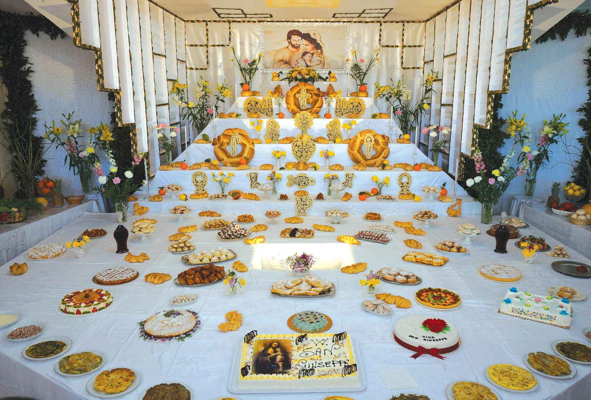 Large community altar with various desert cakes.