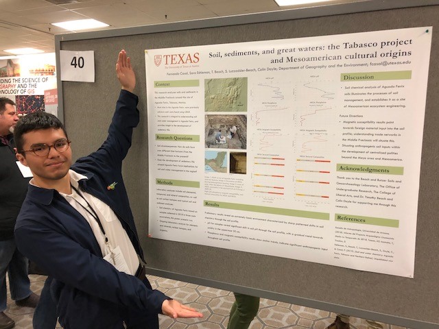 Fernando Casal stands next to his poster presentation.