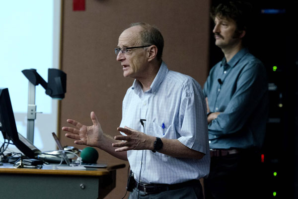 Jamie Pennebaker speaking at class lectern with Sam Gosling in background.