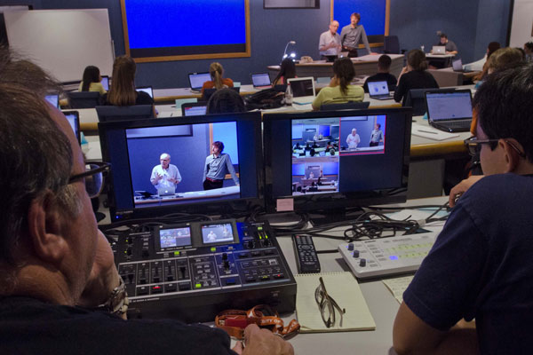 Psychology intro course taught in the format synchronous massive online course (SMOC) as seen from the classroom room perspective with computer screens.