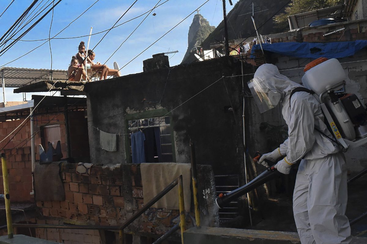 man disinfects street in Rio de Janeiro Brazil