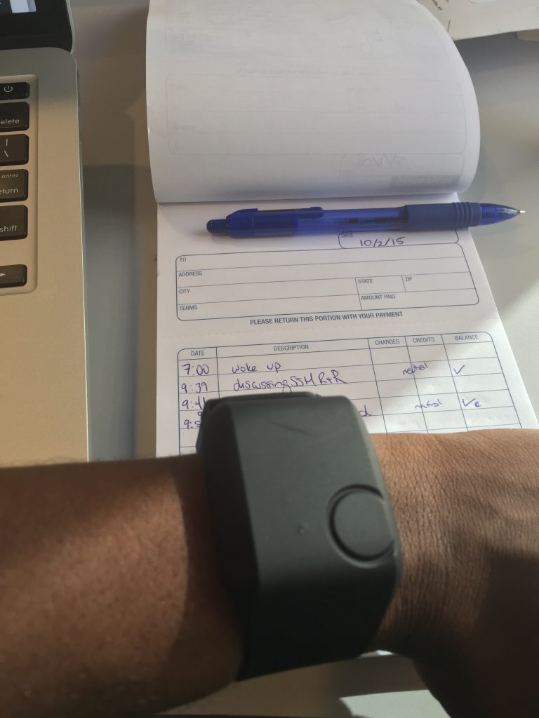 Wristband monitor and daily diary with blue pen to record how experiences of racism and discrimination impact the body’s stress response.