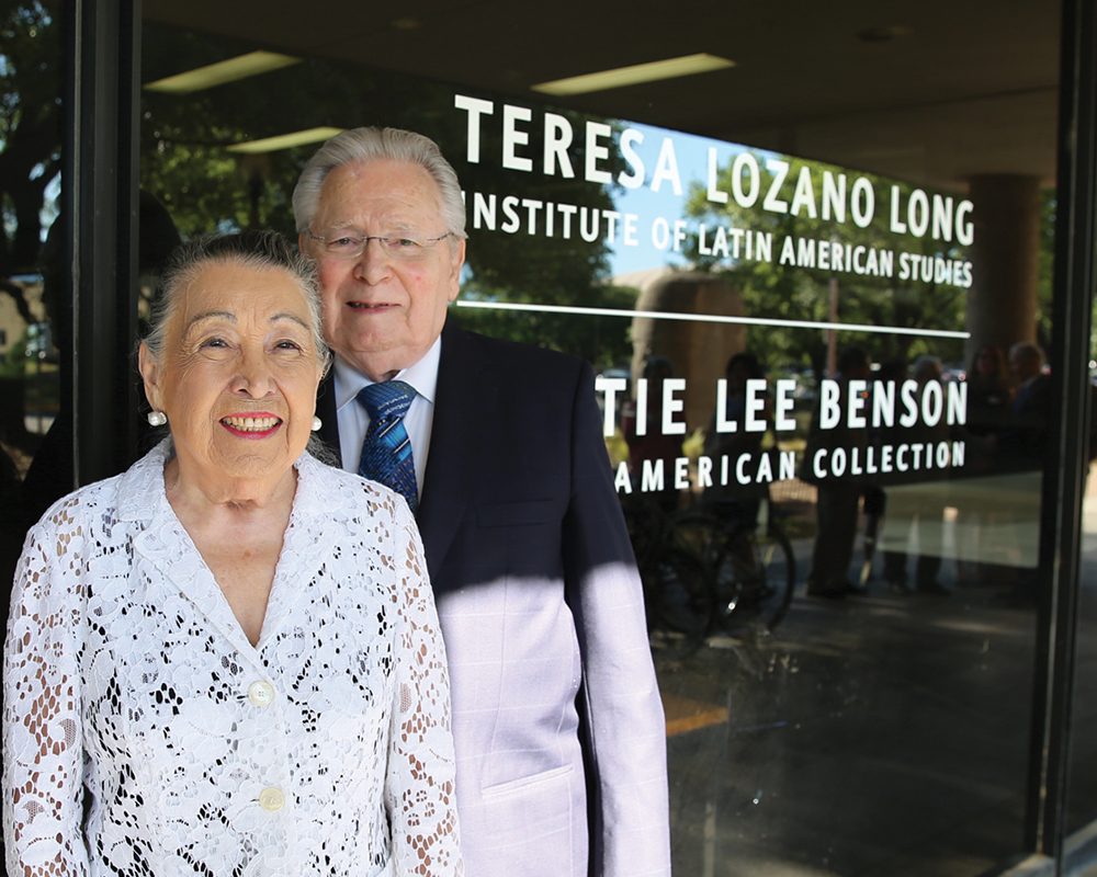 Teresa Lozana Long stands with her husband Joe in front of the building named after them.