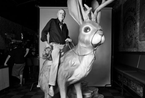 Don Graham sits on the large jackalope statue in downtown Austin.