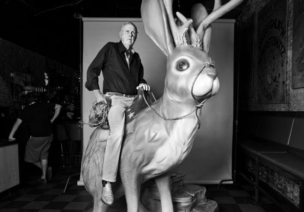 Don Graham sits on the large jackalope statue in downtown Austin.